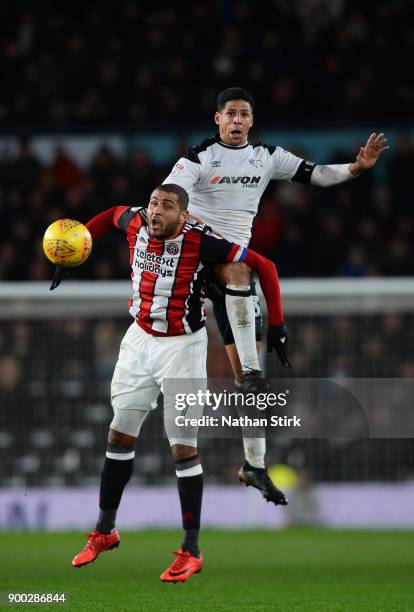 Curtis Davies of Derby County and Leon Clarke of Sheffield United compete for the ball during the Sky Bet Championship match between Derby County and...