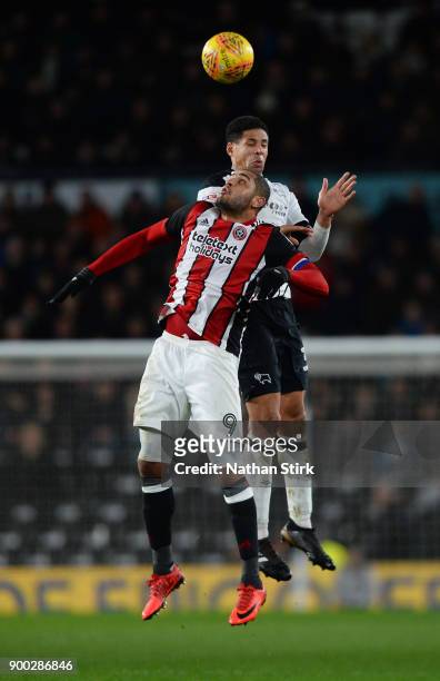 Curtis Davies of Derby County and Leon Clarke of Sheffield United compete for the ball during the Sky Bet Championship match between Derby County and...