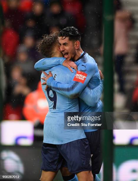 Newcastle striker Ayoze Perez celebrates with Dwight Gayle after scoring the winning goal during the Premier League match between Stoke City and...