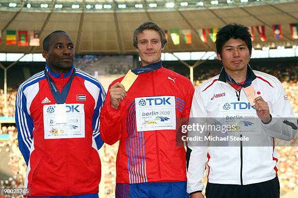 Guillermo Martinez of Cuba receives the silver medal, Andreas Thorkildsen of Norway the gold medal and Yukifumi Murakami of Japan the bronze medal...