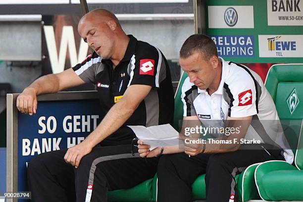 Head coach Michael Frontzeck and assistant coach Frank Geideck of Moenchengladbach look dejected during the Bundesliga match between Werder Bremen...