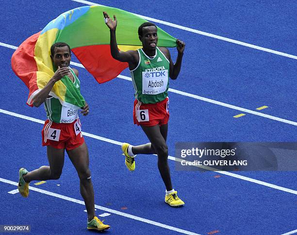 Ethiopia's Kenenisa Bekele and Ethiopia's Ali Abdosh celebrate after the men's 5000m race of the 2009 IAAF Athletics World Championships on August...