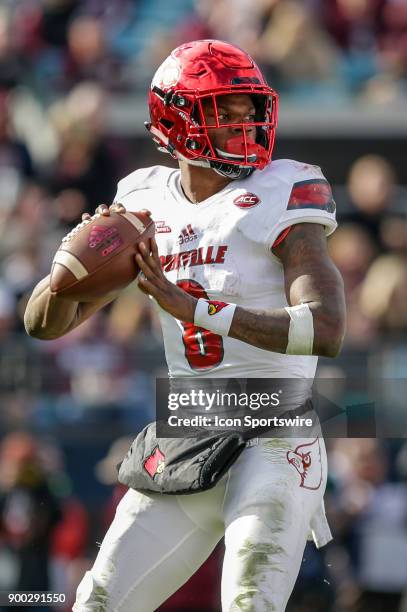 Louisville Cardinals quarterback Lamar Jackson looks for a receiver during the game between the Louisville Cardinals and the Mississippi State...