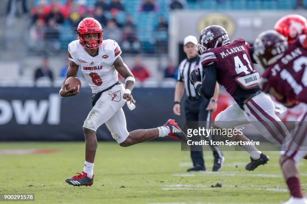 Louisville Cardinals quarterback Lamar Jackson runs during the game between the Louisville Cardinals and the Mississippi State Bulldogs on December...