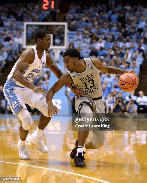 Bryant Crawford of the Wake Forest Demon Deacons moves the ball against Kenny Williams of the North Carolina Tar Heels at Dean Smith Center on...