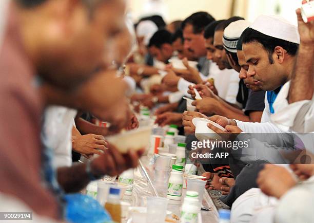 Muslim men break their fast at a mosque in the Saudi Red Sea port of Jeddah on August 23, 2009. Muslims entered the fasting and feasting month of...