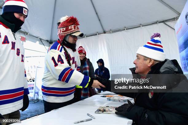 Former New York Rangers player, Rod Gilbert, poses with fans prior to the 2018 Bridgestone NHL Winter Classic between the New York Rangers and the...