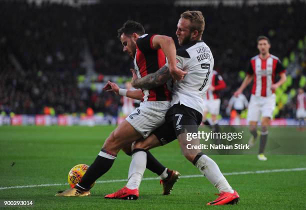 Johnny Russell of Derby County and George Baldock of Sheffield United in action during the Sky Bet Championship match between Derby County and...