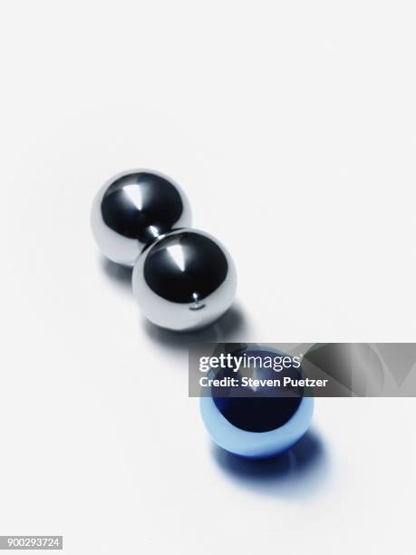 three ball bearings one colored blue - bearings metal stock pictures, royalty-free photos & images