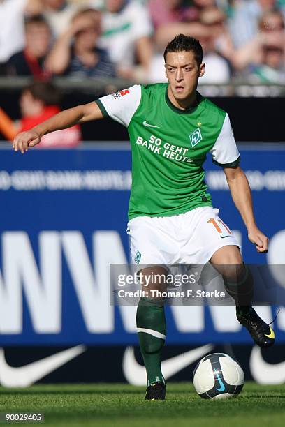 Mesut Oezil of Bremen kicks the ball during the Bundesliga match between Werder Bremen and Borussia Moenchengladbach at the Weser Stadium on August...