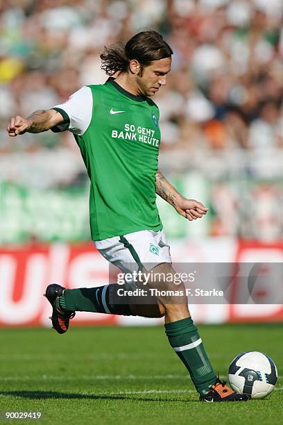 Torsten Frings of Bremen kicks the ball during the Bundesliga match between Werder Bremen and Borussia Moenchengladbach at the Weser Stadium on...