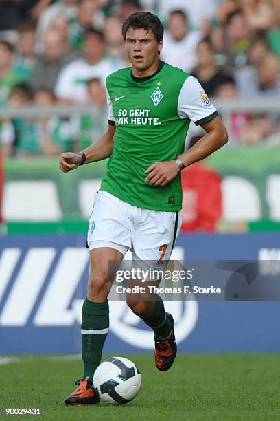 Sebastian Boenisch of Bremen runs with the ball during the Bundesliga match between Werder Bremen and Borussia Moenchengladbach at the Weser Stadium...