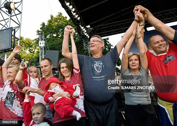 President of Latvia Valdis Zatlers waves during the Heartbeats for the Baltics relay in Riga on August 23, 2009. Estonia, Latvia and Lithuania...