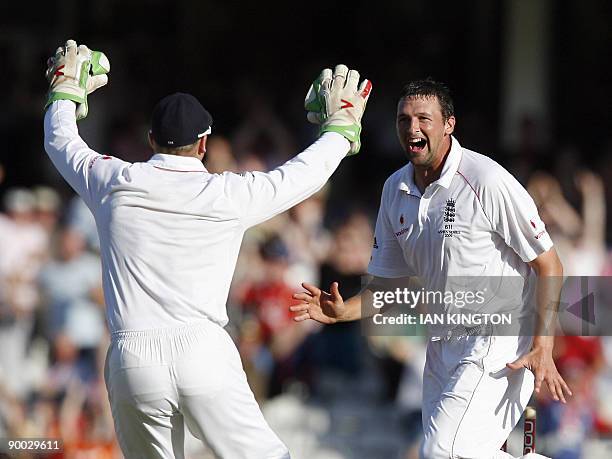 England's Steve Harmison celebrates the wicket of Australia's Stuart Clark with England's Matt Prior on the fourth day of the fifth and final Ashes...