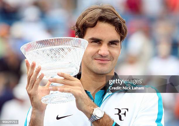 Roger Federer of Switzerland holds the winners trophy aloft after defeating Novak Djokovic of Serbia in the Singles Final during day seven of the...