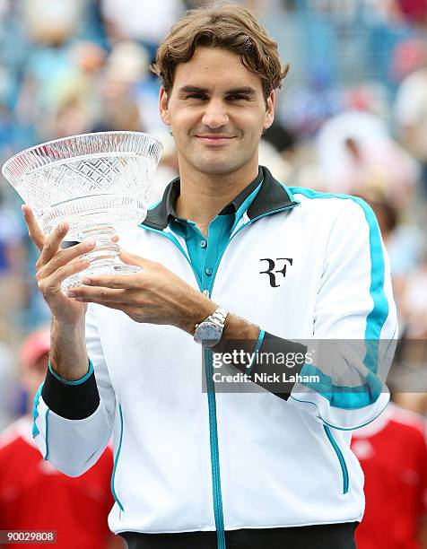 Roger Federer of Switzerland holds the winners trophy aloft after defeating Novak Djokovic of Serbia in the Singles Final during day seven of the...