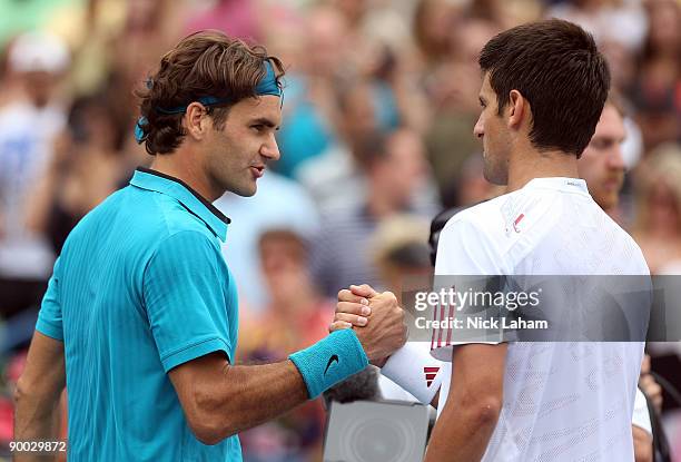 Roger Federer of Switzerland shakes hand at the net after defeating Novak Djokovic of Serbia in the Singles Final during day seven of the Western &...