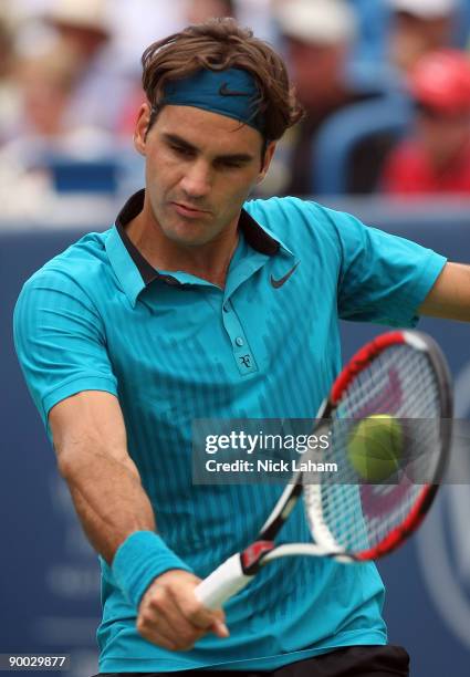Roger Federer of Switzerland hits a backhand against Novak Djokovic of Serbia in the Singles Final during day seven of the Western & Southern...