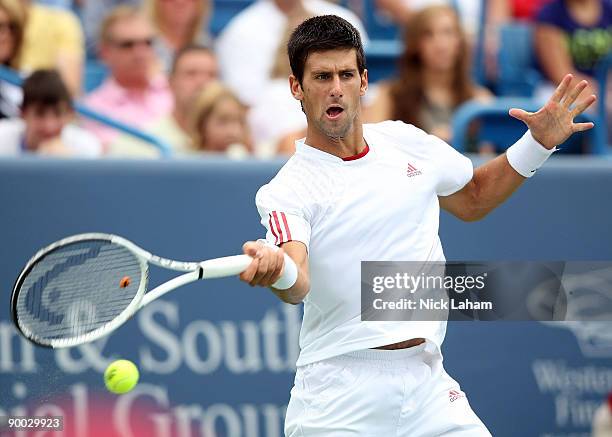 Novak Djokovic of Serbia hits a forehand against Roger Federer of Switzerland in the Singles Final during day seven of the Western & Southern...