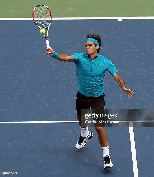 Roger Federer of Switzerland hits an overhead volley against Novak Djokovic of Serbia in the Singles Final during day seven of the Western & Southern...