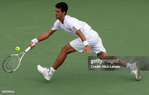 Novak Djokovic of Serbia hits a forehand against Roger Federer of Switzerland in the Singles Final during day seven of the Western & Southern...