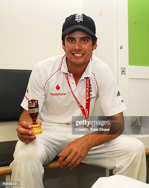 Alastair Cook of England poses with the Ashes urn in the dressing room after day four of the npower 5th Ashes Test Match between England and...