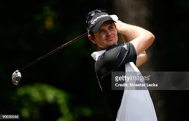 Justin Rose of England watches his tee shot on the 2nd hole during the final round of the Wyndham Championship at Sedgefield Country Club on August...