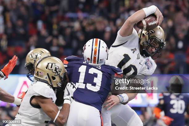 McKenzie Milton of the UCF Knights scores a rushing touchdown in the second quarter against the Auburn Tigers during the Chick-fil-A Peach Bowl at...