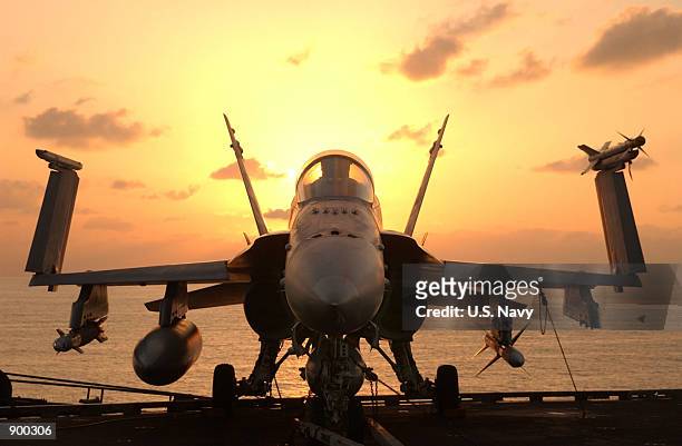 After an early morning round of flight operations, an F/A-18 Hornet awaits the next round of combat flight operations December 18, 2001 aboard USS...