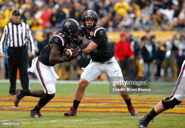 Quarterback Jake Bentley of the South Carolina Gamecocks hands off to running back Ty'Son Williams during the first quarter of the Outback Bowl NCAA...