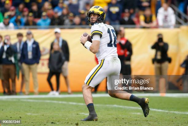 Quarterback Brandon Peters of the Michigan Wolverines looks for a receiver during the first quarter of the Outback Bowl NCAA college football game...