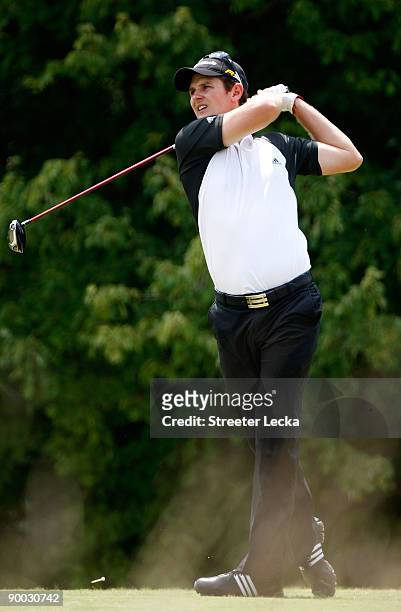 Justin Rose of England watches his tee shot on the 5th hole during the final round of the Wyndham Championship at Sedgefield Country Club on August...