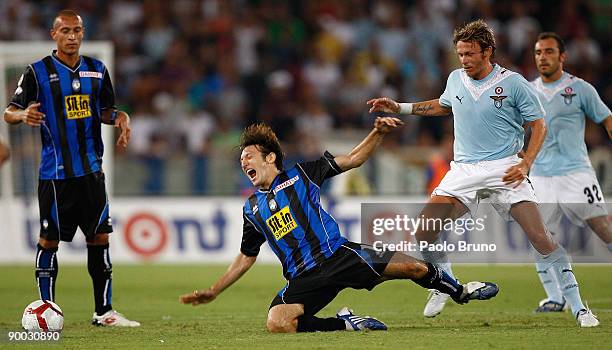 Edgar Barreto of Atalanta falls in a challenge with Roberto Baronio of Lazio during the Serie A match between SS Lazio and Atalanta BC at Olimpico...