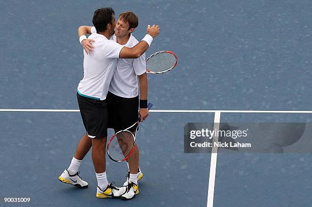 Nenad Zimonjic of Serbia and Daniel Nestor of Canada celebrate match point after defeating Bob Bryan and Mike Bryan in the Doubles Final during day...