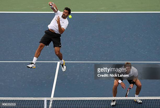 Nenad Zimonjic of Serbia hits an overhead volley alongside partner Daniel Nestor of Canada in their match against Bob Bryan and Mike Bryan in the...