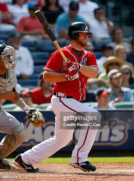 Brian McCann of the Atlanta Braves hits a two-run single in the bottom of the eighth inning against the Florida Marlins on August 23, 2009 at Turner...