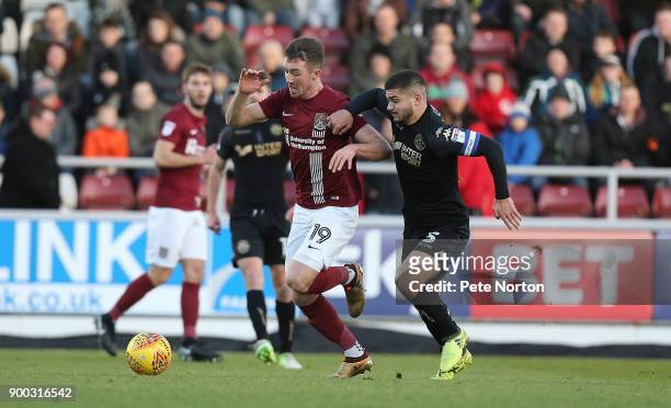 Chris Long of Northampton Town moves forward with the ball under pressure from Sam Morsy of Wigan Athletic during the Sky Bet League One match...