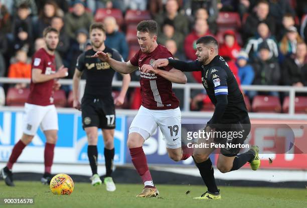 Chris Long of Northampton Town moves forward with the ball under pressure from Sam Morsy of Wigan Athletic during the Sky Bet League One match...