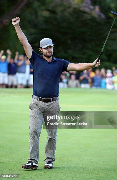 Ryan Moore celebrates after making a putt to win the Wyndham Championship in a sudden death playoff against Kevin Stadler and Jason Bohn at...