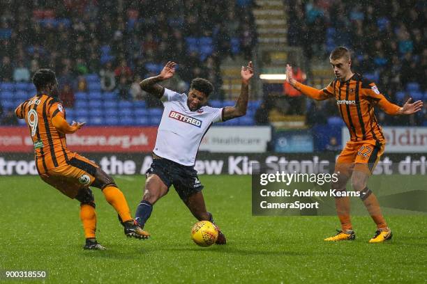 Bolton Wanderers' Mark Little competing with Hull City's Nouha Dicko during the Sky Bet Championship match between Bolton Wanderers and Hull City at...