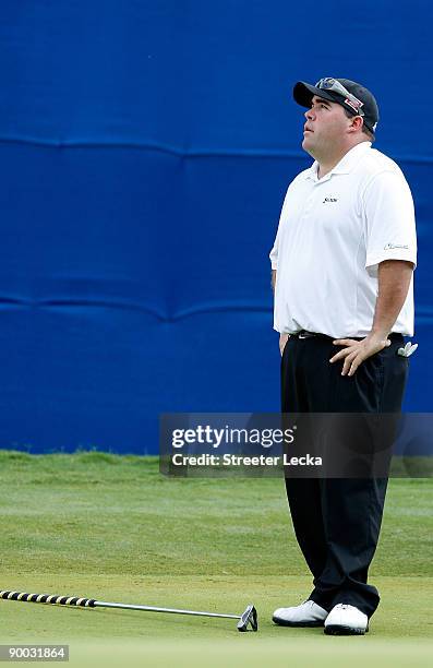 Kevin Stadler reacts to missing a putt on the 18th hole during the final round of the Wyndham Championship at Sedgefield Country Club on August 23,...