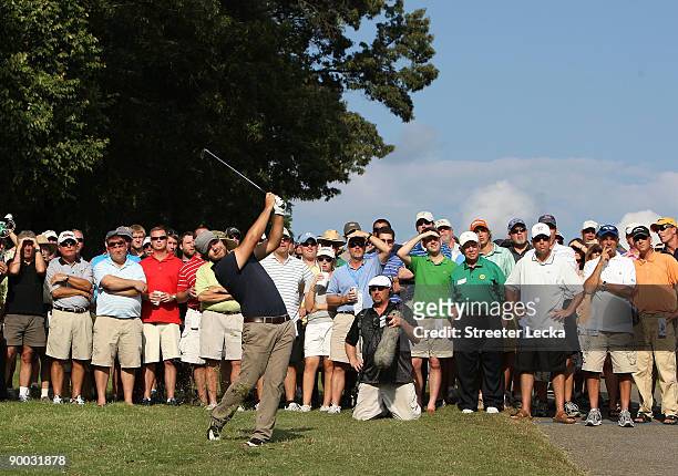 Ryan Moore hits from the rough on the 18th hole during the final round of the Wyndham Championship at Sedgefield Country Club on August 23, 2009 in...