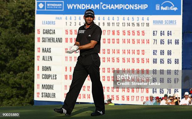 Sergio Garcia of Spain walks in front of the leaderboard on the 18th green during the final round of the Wyndham Championship at Sedgefield Country...