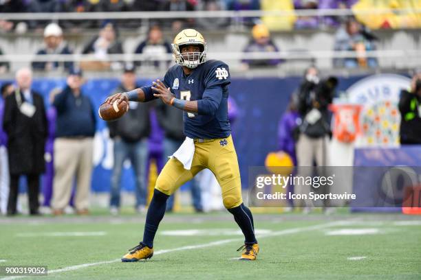 Notre Dame Fighting Irish quarterback Brandon Wimbush looks to pass during the first half of the Citrus Bowl game between the Notre Dame Fighting...