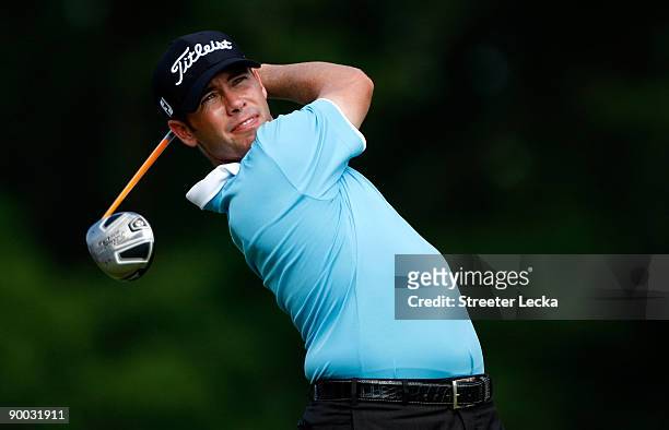Chez Reavie watches his tee shot on the 18th hole during the final round of the Wyndham Championship at Sedgefield Country Club on August 23, 2009 in...