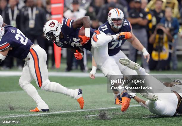 Kerryon Johnson of the Auburn Tigers runs with the ball in the first half against the UCF Knights during the Chick-fil-A Peach Bowl at Mercedes-Benz...