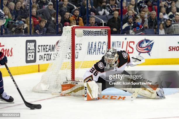 Anaheim Ducks goalie John Gibson drops to the ice to protect the goal during the third period in a game between the Columbus Blue Jackets and the...