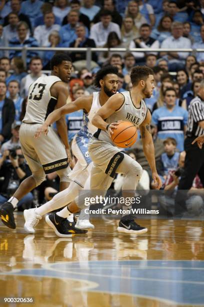 Mitchell Wilbekin of the Wake Forest Demon Deacons dribbles the ball against the North Carolina Tar Heels on December 30, 2017 at the Dean Smith...