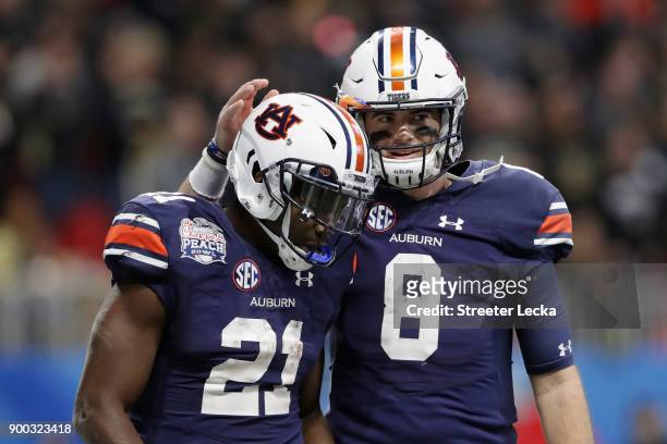 Kerryon Johnson of the Auburn Tigers celebrates with Jarrett Stidham after scoring a touchdown in the third quarter against the UCF Knights during...