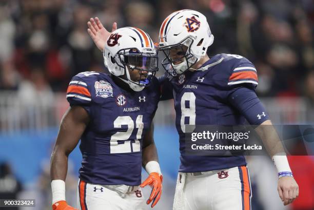 Kerryon Johnson of the Auburn Tigers celebrates with Jarrett Stidham after scoring a touchdown in the third quarter against the UCF Knights during...